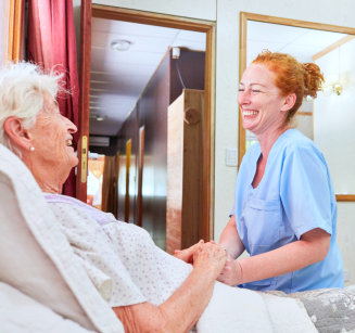 caretaker smile at elderly woman