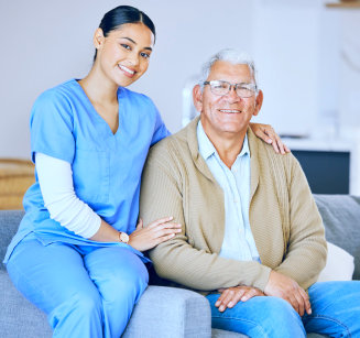 elderly man and caretaker smiling