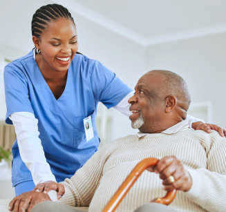 caretaker helps the elderly man