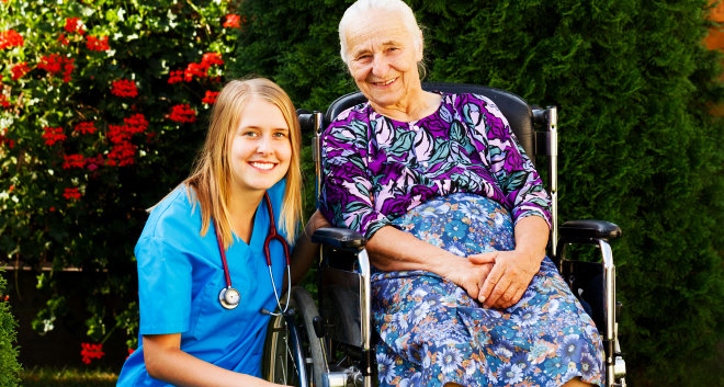 caretaker and elderly woman smiling