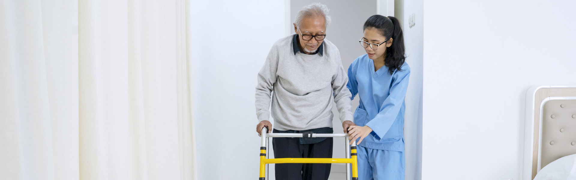 caretaker helps the elderly man