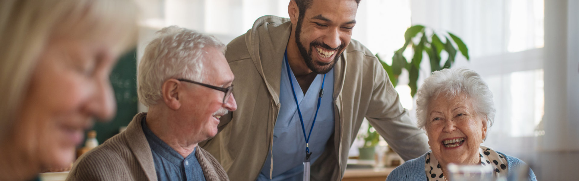 caretaker and elderly couple smiling