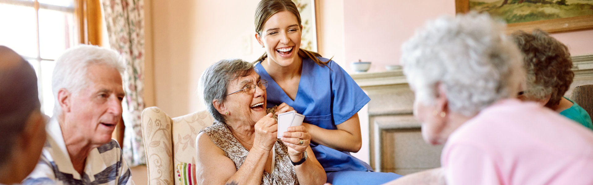 elderly people laughing with caregiver